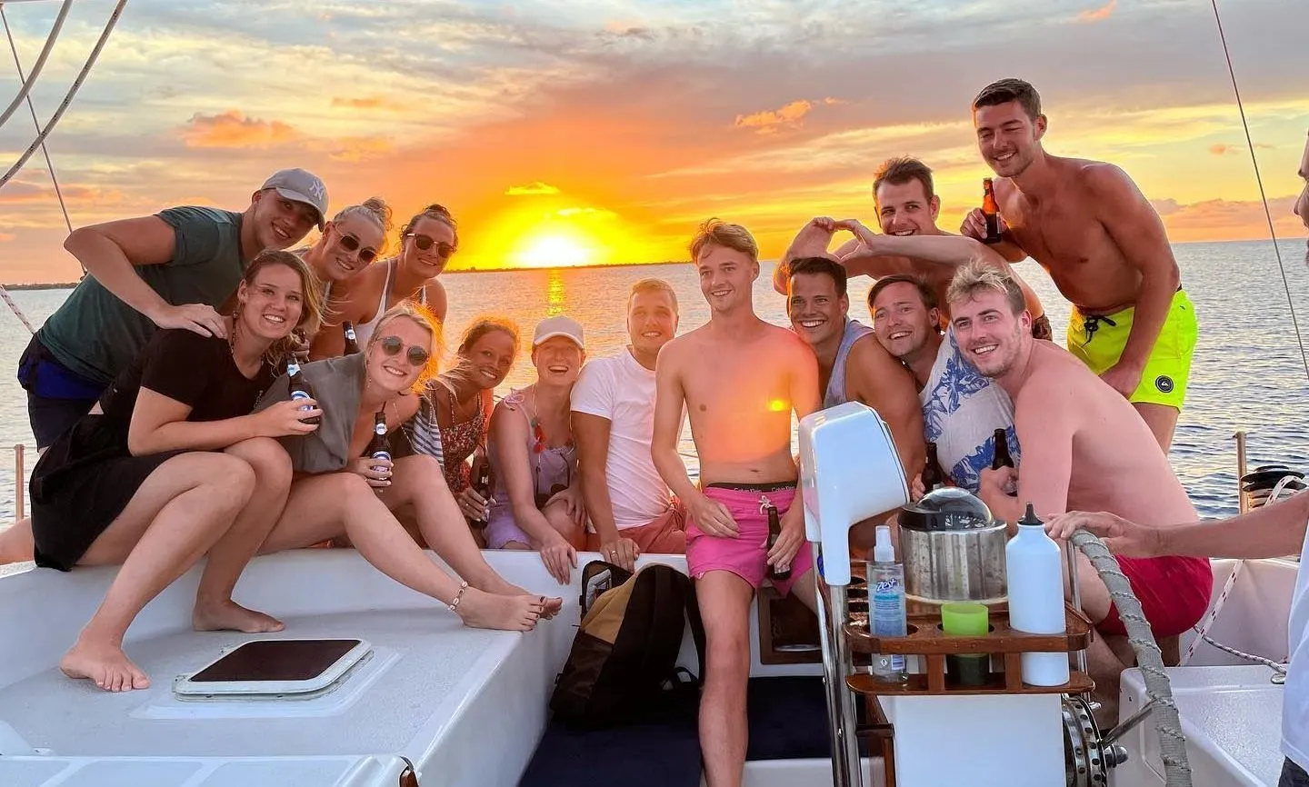 Group enjoying a private sailing trip at sunset