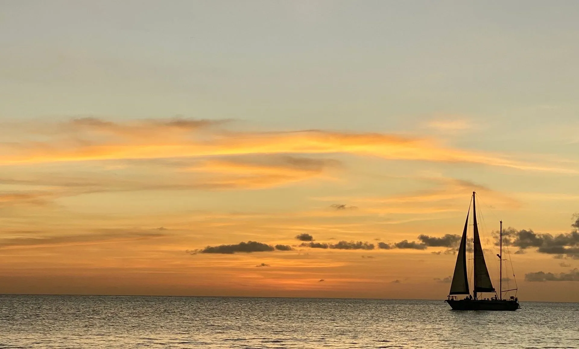 Sailboat heading into the setting sun off the coast of Bonaire
